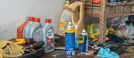 used oil canisters on dirty garage workbench