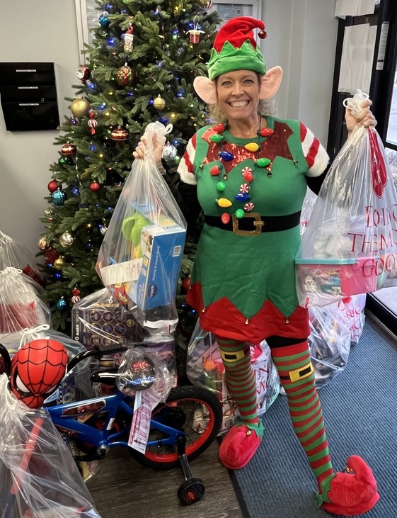 Employee dressed as elf for Angel Tree