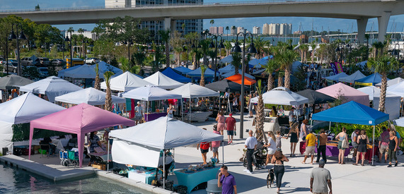 people walking around at the market marie