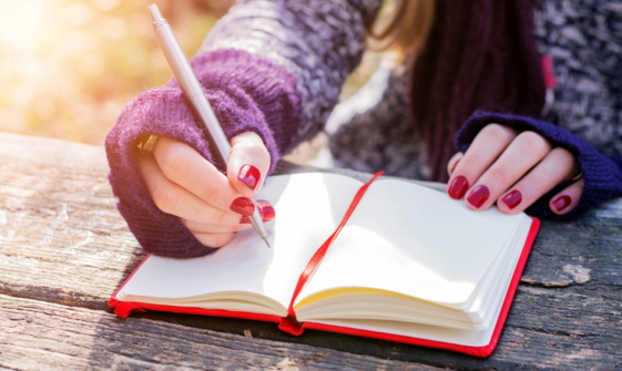 This is an image of someone writing in a journal