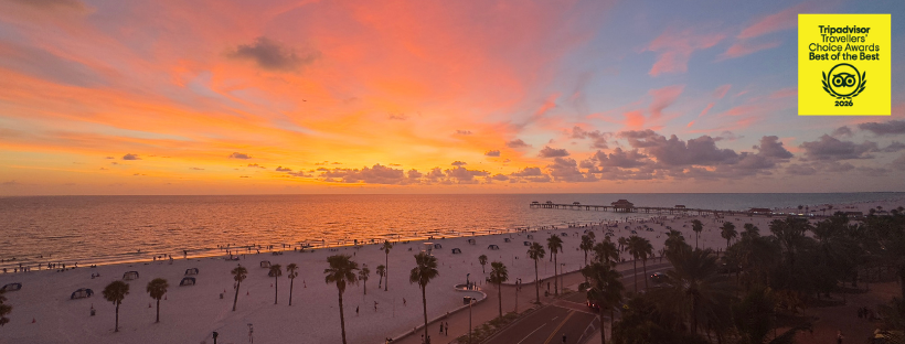 Clearwater Beach at Sunset with Travelers' Choice Awards logo in top corner