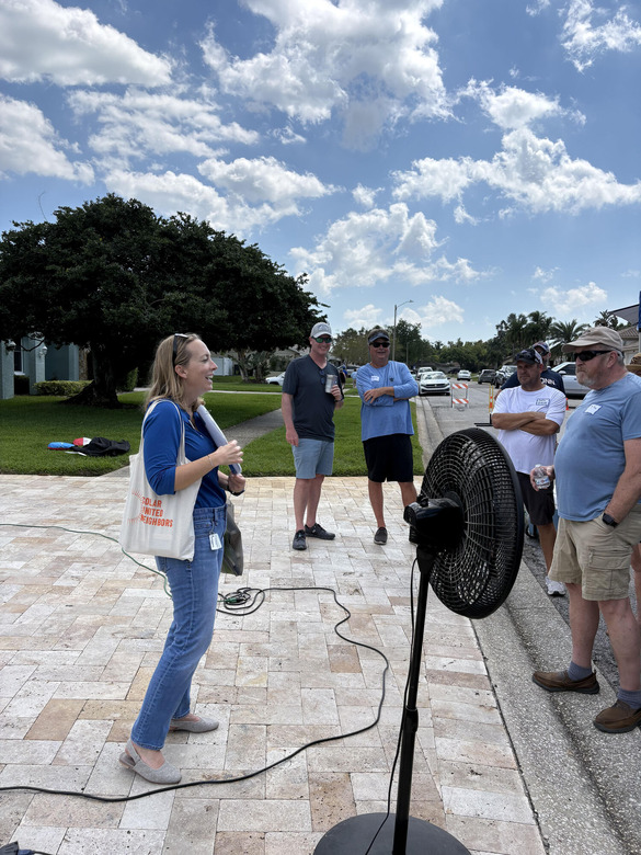 Sustainability manager speaking to a group of residents about Adopt-a-Drain