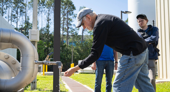 man putting water in  hands at the water treatment center