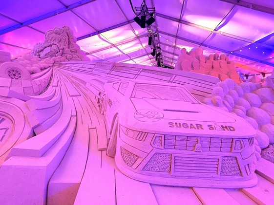 Pier 60 Sugar Sand Festival sand sculpture of a car with pink hues