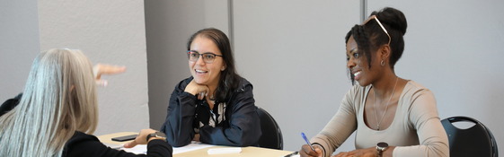 a resident listening to two staff people talk
