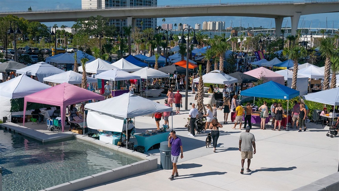 This is an image of people and tents at the Market Marie event in Clearwater