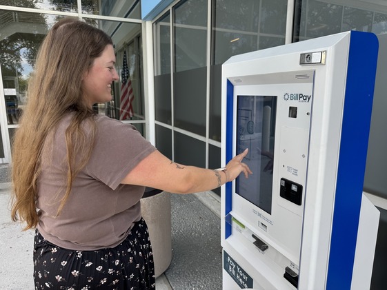 woman using payment Kiosk
