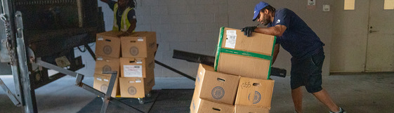 people moving boxes to a truck