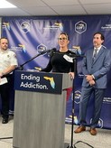State officials and local partners address the audience.