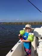 kid fishing on boat