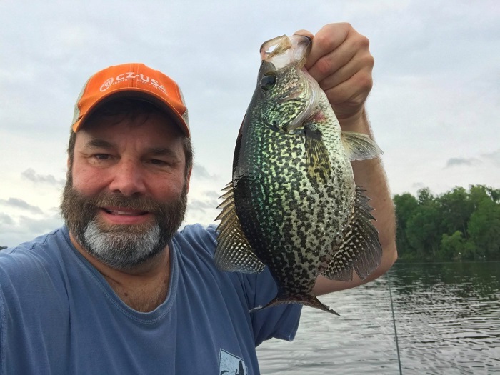 angler holding crappie