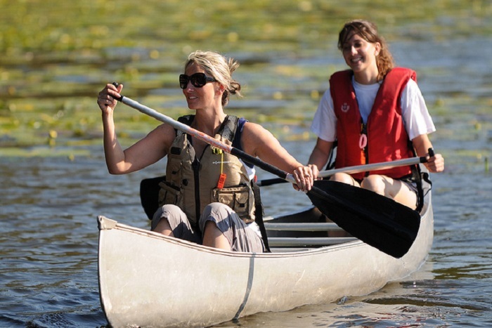 women paddling canoe