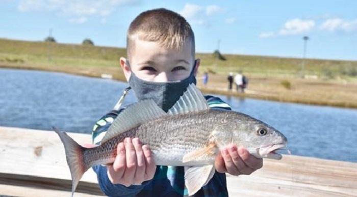 youth holding fish