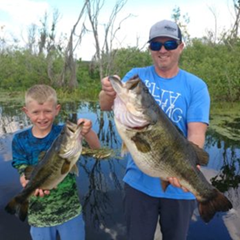 anglers holding trophy bass