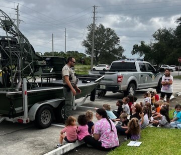 Officer educating youth about boating safety