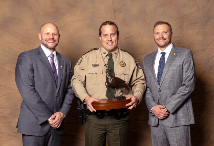 Officer Hoyle holding award