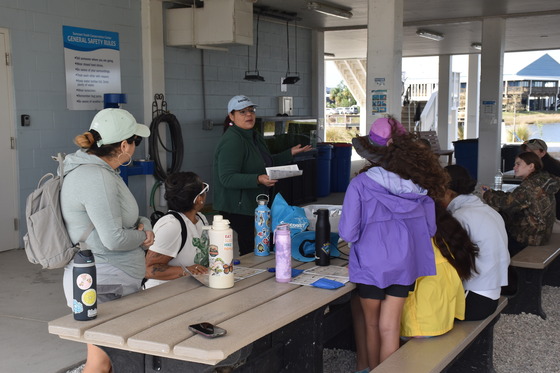 Florida Project WILD Coordinator, Yatska Valentín teaches fishing regulations to a group of fishing clinic participants