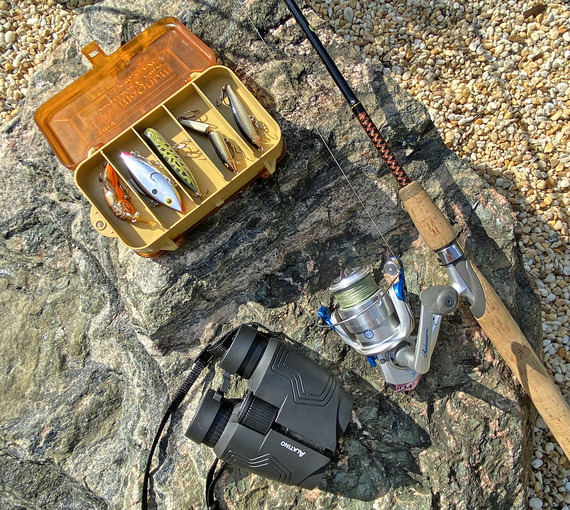 A fishing rod, a tackle box and binoculars.