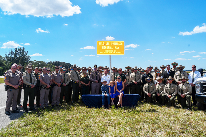 officers and family at Kyle Lee Patterson Memorial Way dedication ceremony