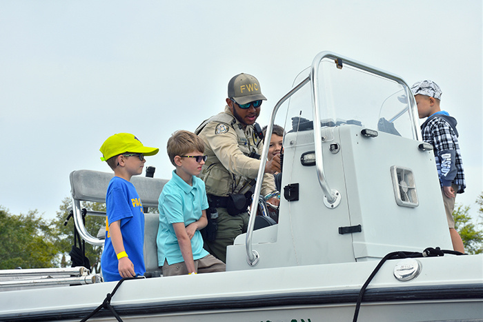 officer showing kids FWC vessel
