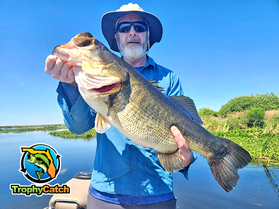 Angler with trophy Florida bass, TrophyCatch logo