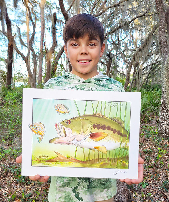 Sebastian Romo holds his award-winning artwork of a Florida bass