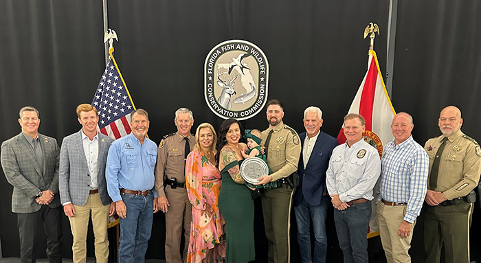 Officer Wild getting award from FWC Commission