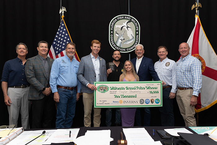 python challenge winner accepting award from FWC Commission