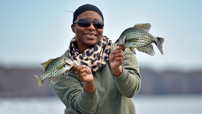 Angler holding black crappie