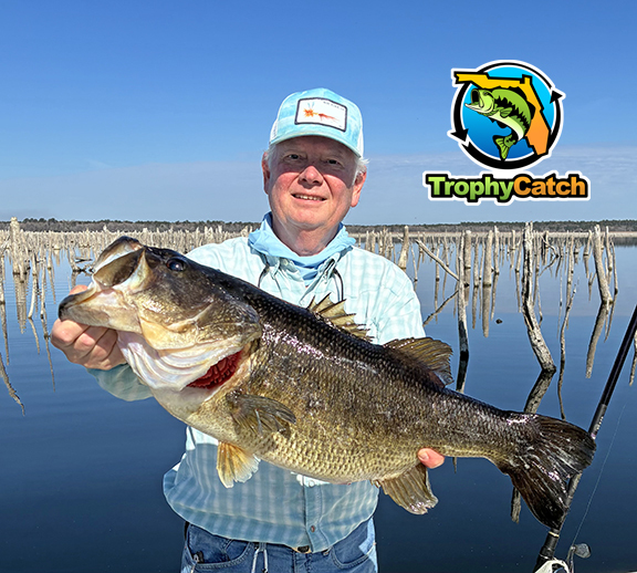 Angler with trophy Florida bass, TrophyCatch logo