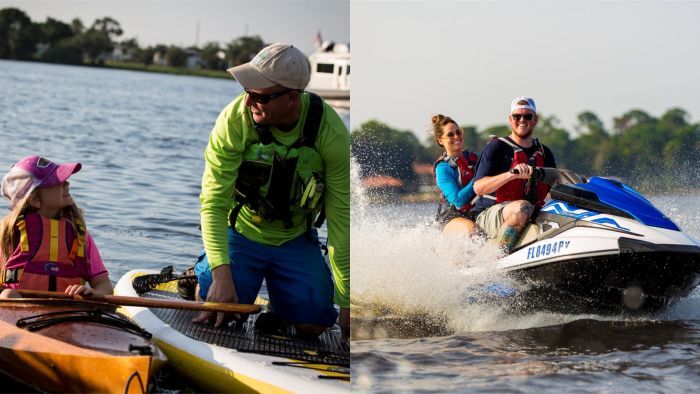 Child in kayak, person kneeling on a paddleboard, and two individulals riding a jet ski 