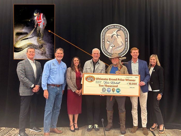 FWC Executive Director, Commissioners and stafff member with Florida Python Challenge Winner holding presented check