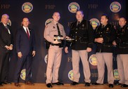 FHP Trooper Scott Mills accepts the 2022 Hurd-Smith Award for the top DUI arrest total.