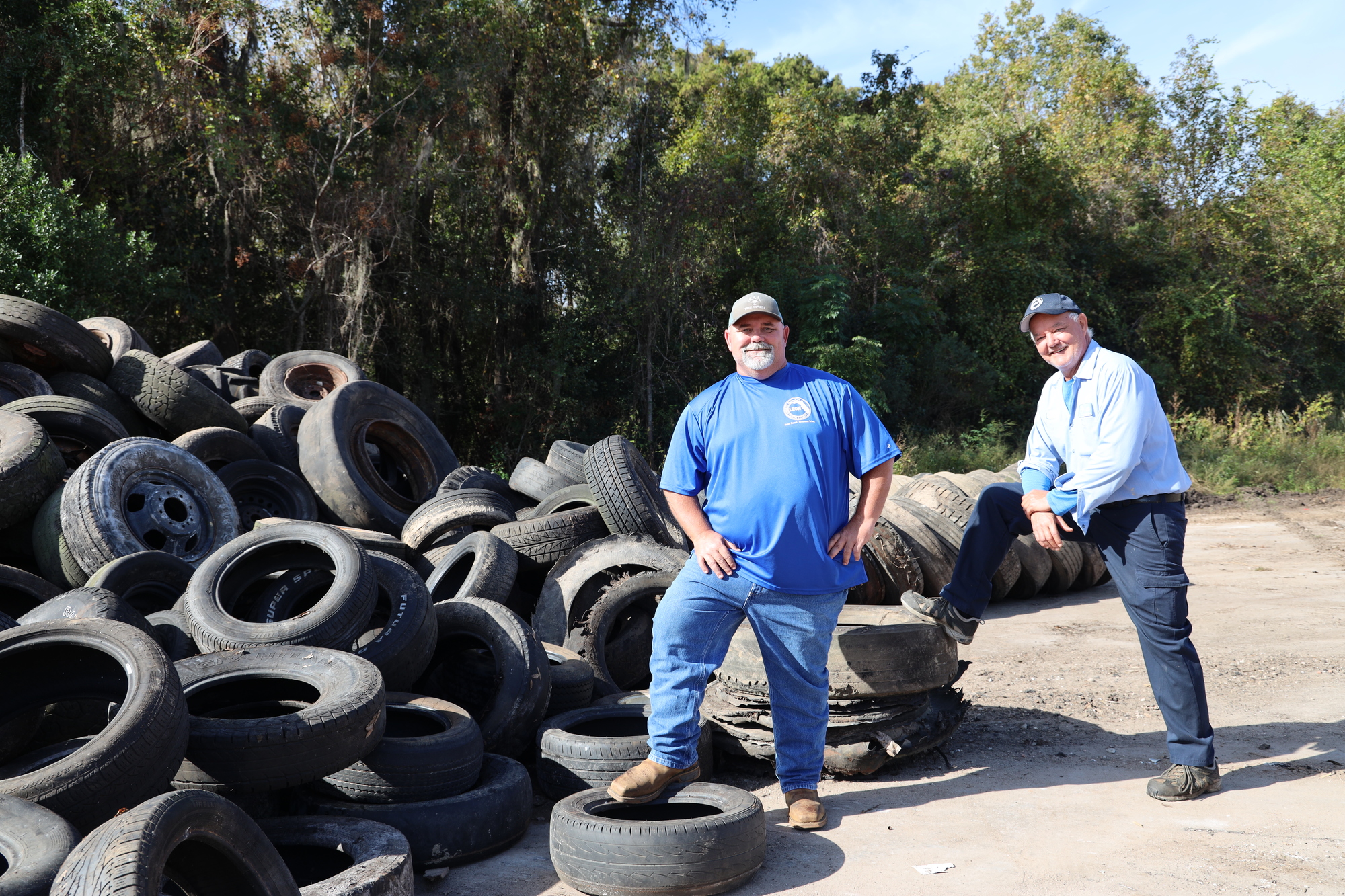 D.J. Newsome & Mike Hamilton move collected tires before they are transferred to a processing facility.