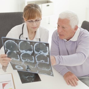 doctor and older patient looking at brain scans