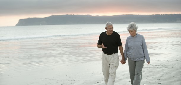 senior couple walking on the beach
