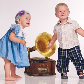 toddlers dancing around a phonograph