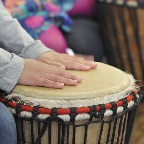 child's hands on a drum