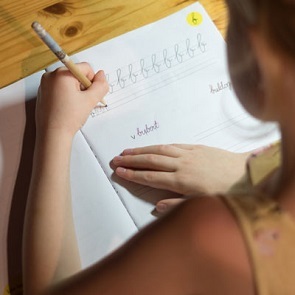girl-practicing-cursive-1-1-r