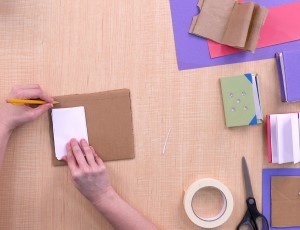 overhead view of two hands making a mini book