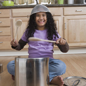 Girl Drumming with Pots and Pans