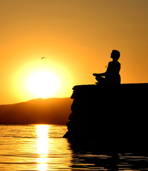 Woman Meditating by the Ocean
