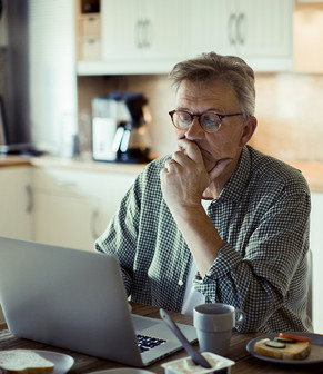 Man Sitting in Front of Laptop