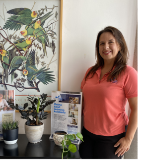 Nora Morales standing in front of Library posters