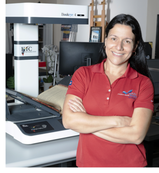 Margarita standing next to a digital scanning machine