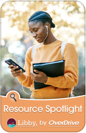 A woman in a park holding a phone and enjoying music with her headphones