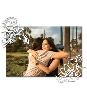 A photo of two friends hugging in a public park