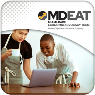 Two coffee shop owners researching on a laptop