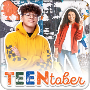 Two teenagers posing in front of a colorful wall covered in peeling stickers and posters