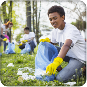 Teen volunteer cleaning up litter in a park